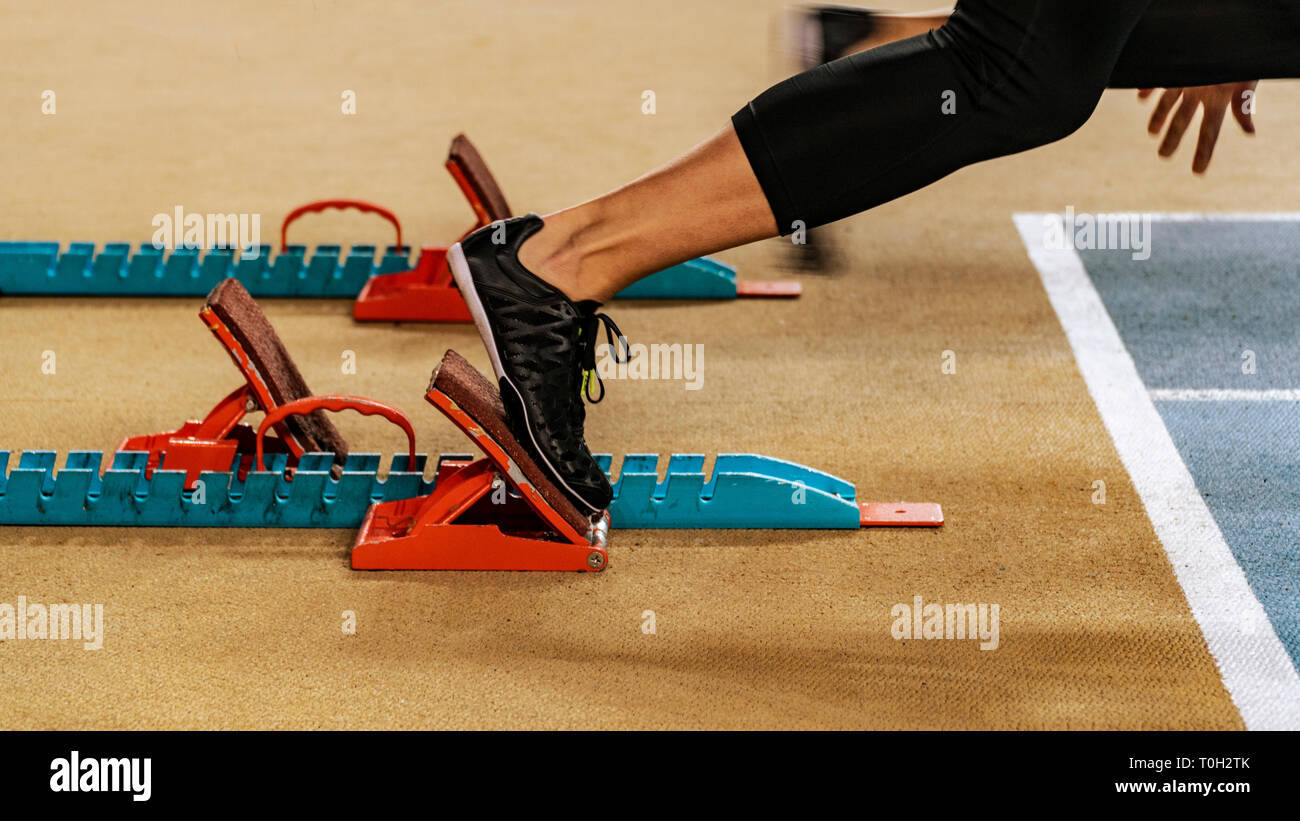 Sport. Sprinter leaving starting blocks on the running track Stock Photo Alamy