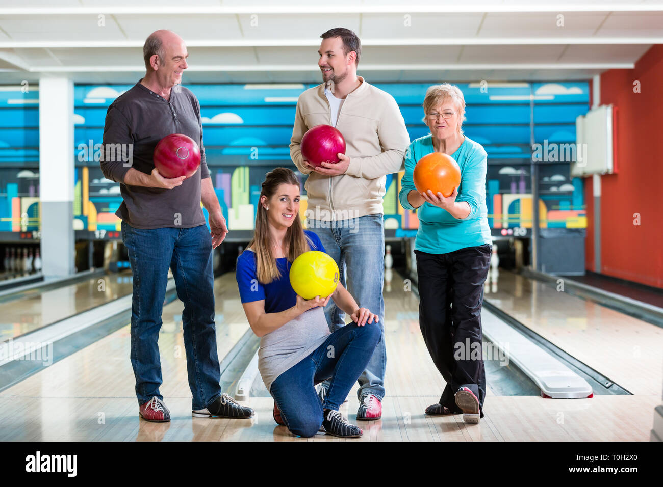 Family holding colorful bowling ball Stock Photo