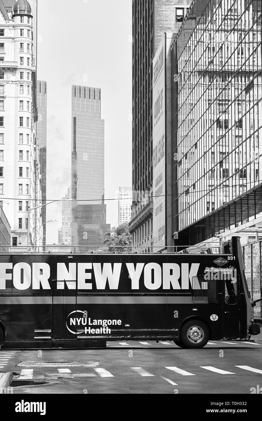 New York, USA - July 01, 2018: Sightseeing bus with For New York sign on a street of Manhattan. Stock Photo