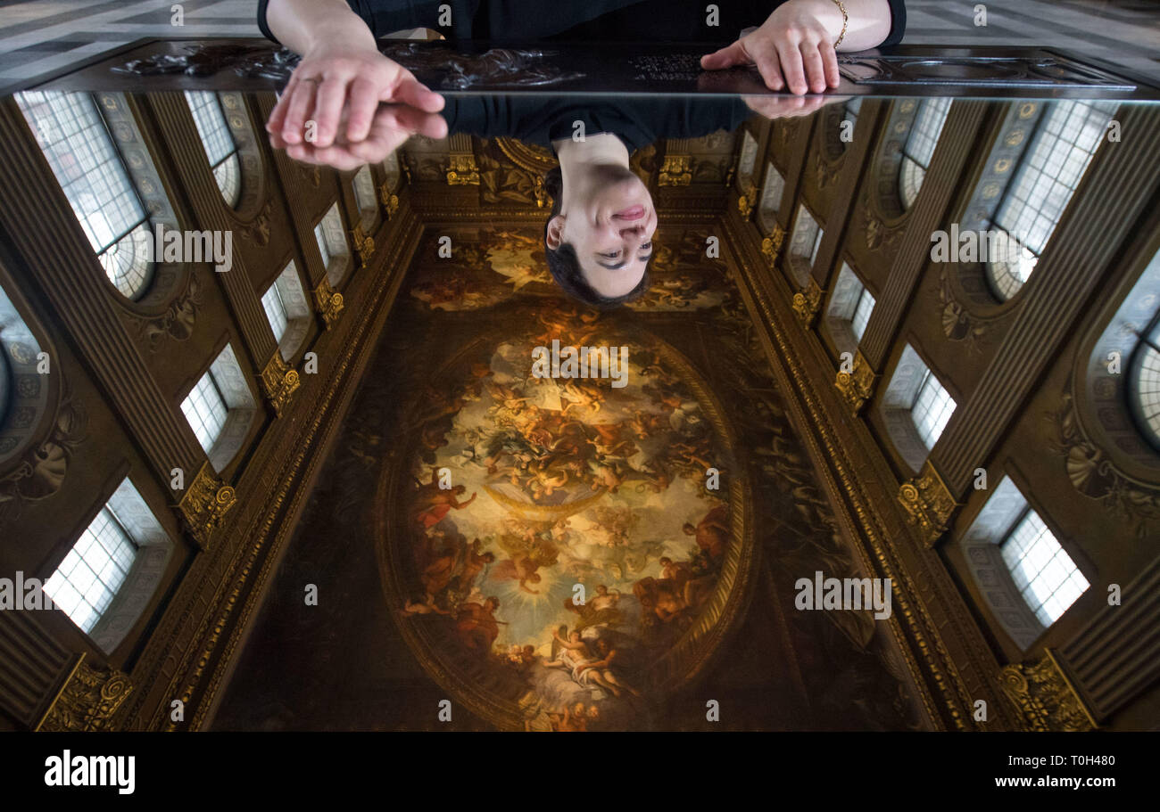 A visitor is seen reflected in a mirror as she views Greenwich's Painted Hall at the Old Royal Naval College in London, before it reopens to the public on March 23 following a two-year National Lottery funded conservation project. Stock Photo