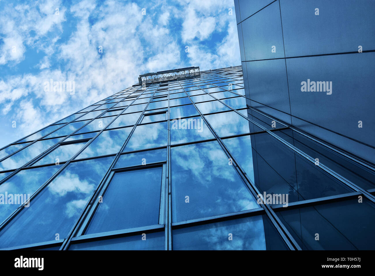 Building facade with blue sky and white clouds Stock Photo - Alamy