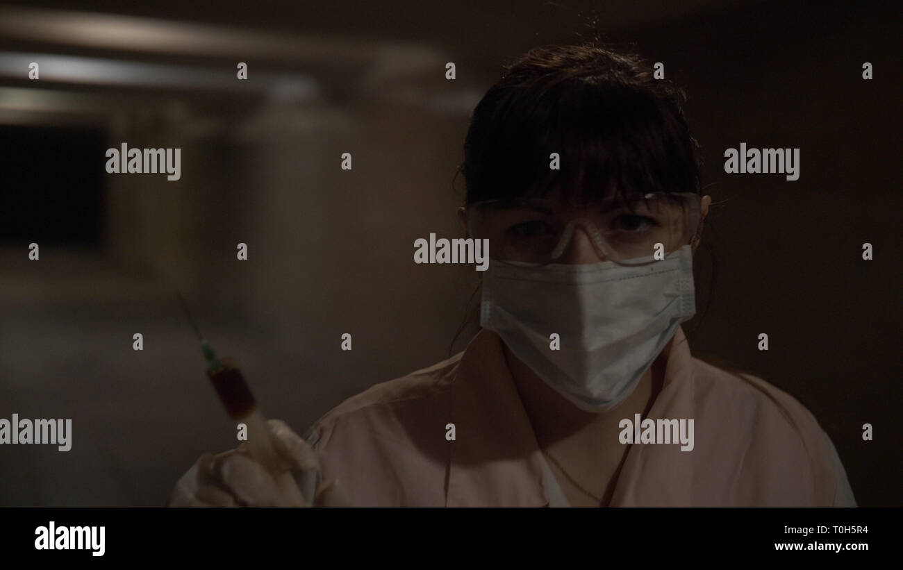 nurse want to make an injection looks at the camera, tunnel Stock Photo ...