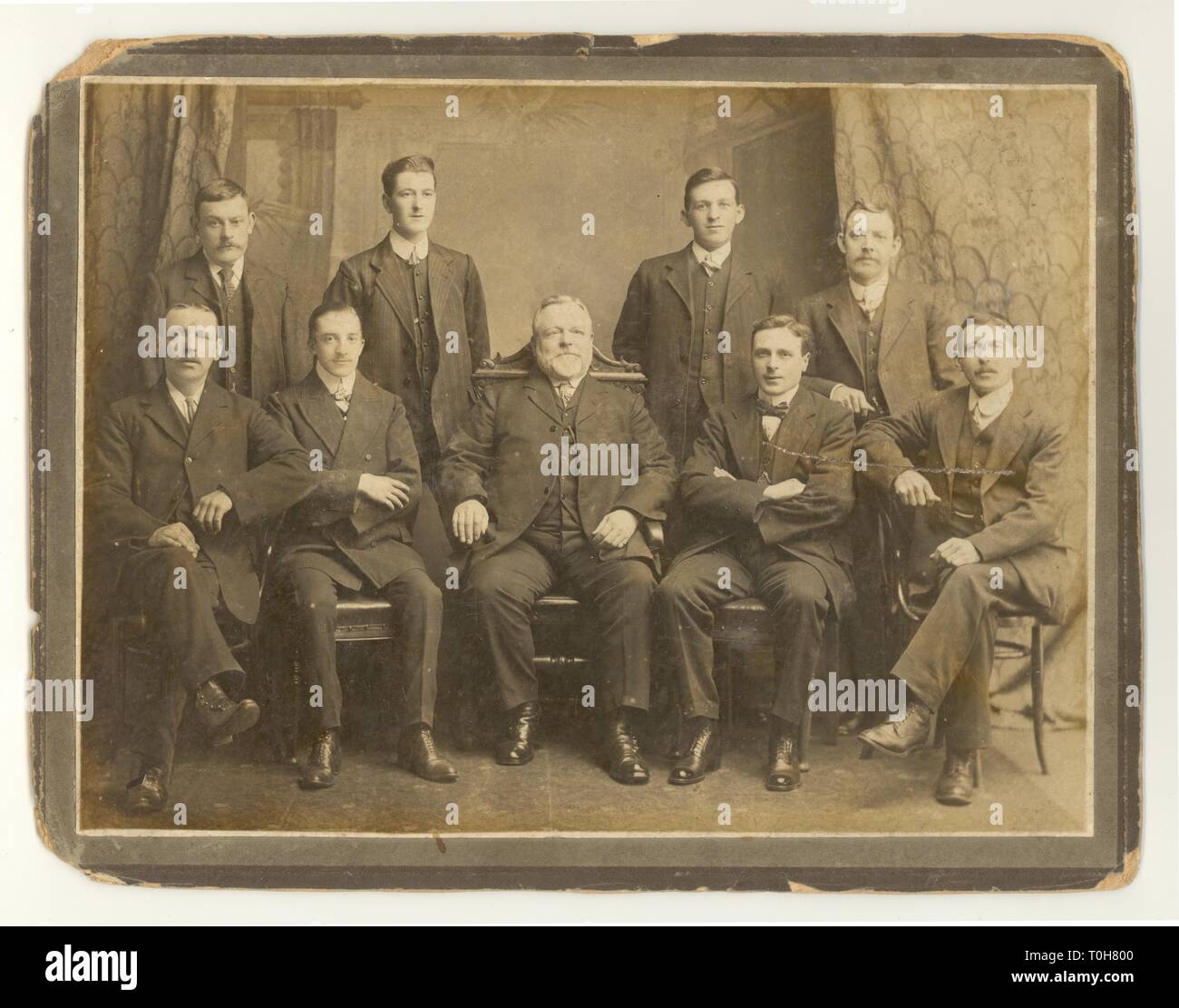 Original Edwardian era formal studio photograph portrait of male staff working at Threlfalls Brewery, boss seated in middle, probably Liverpool, U.K. , dated 1910 Stock Photo