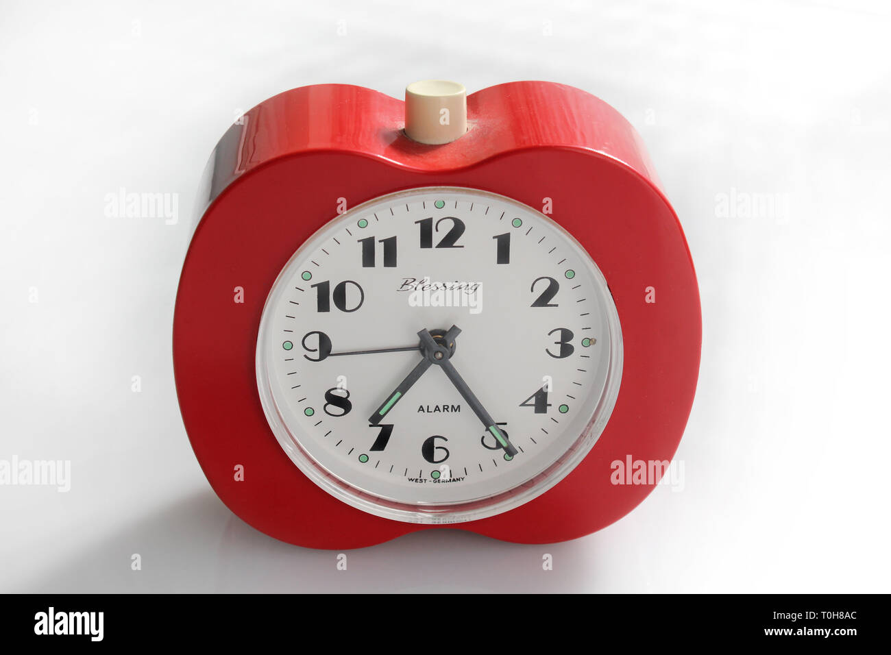 Vintage alarm clock apple inspired, isolated on white background, close