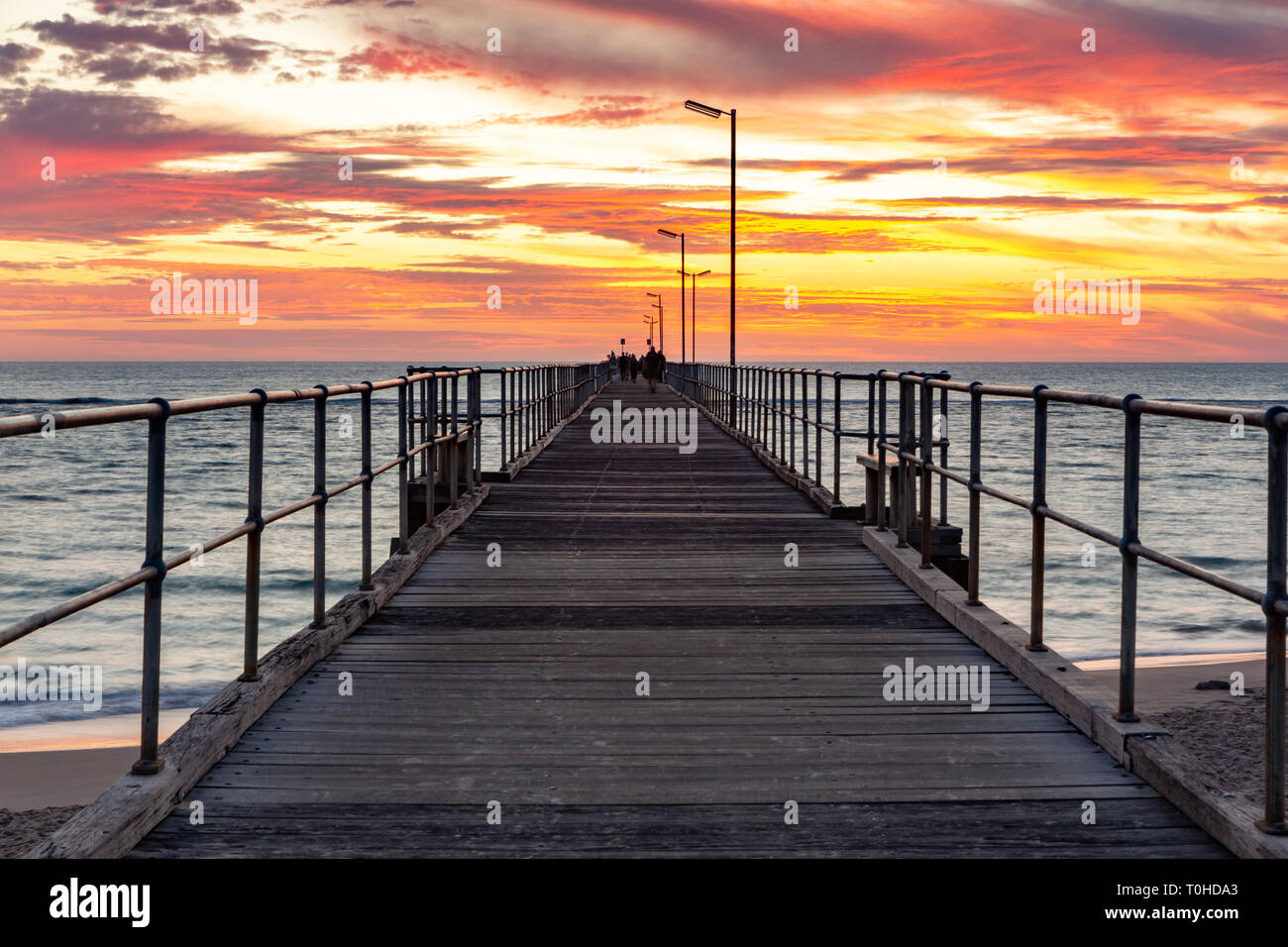 A beautiful sunset at Port Noarlunga on the jetty at Port Noarlunga South Australia Stock Photo