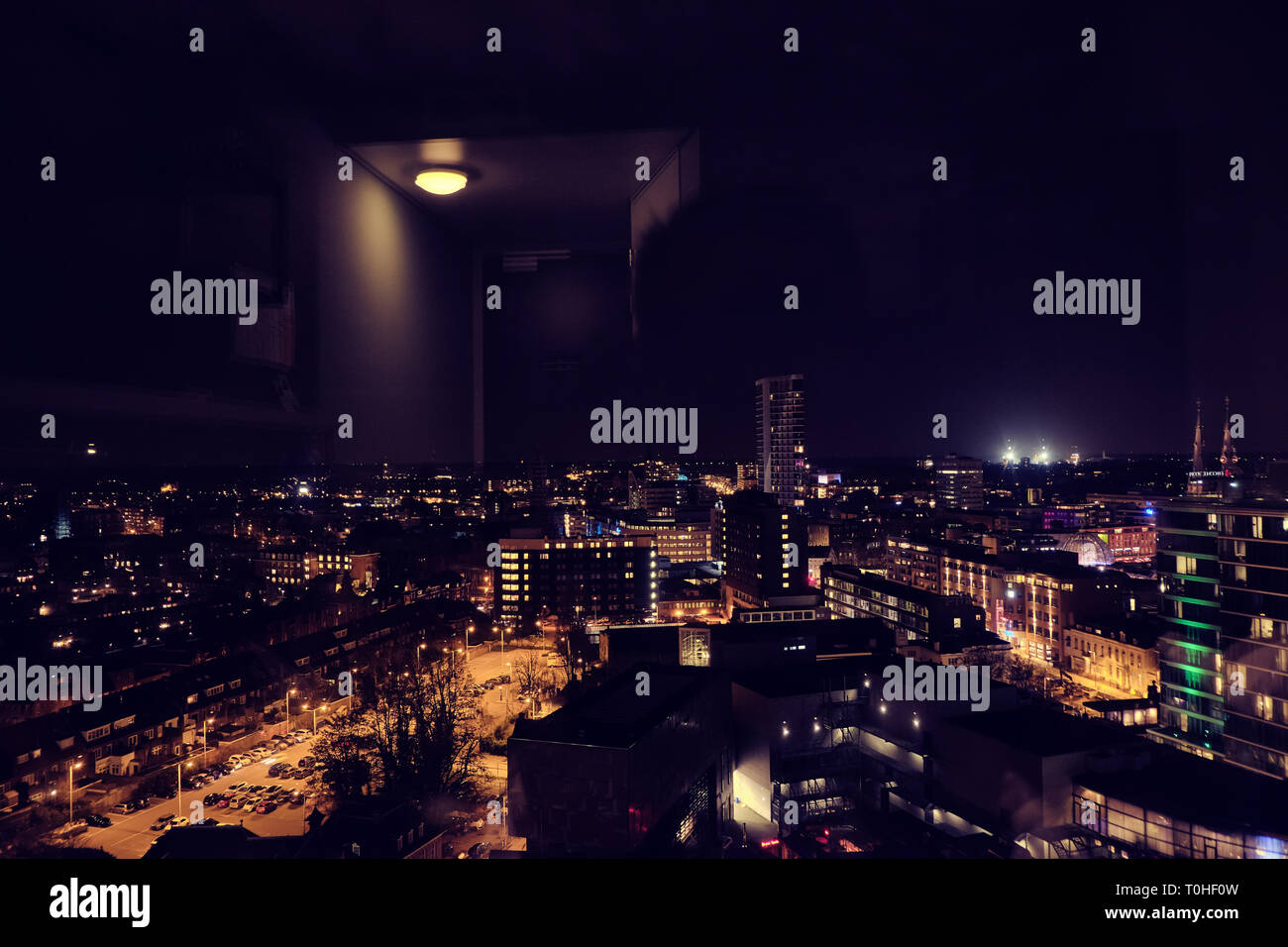 Night skyline of Eindhoven city from a hotel room with reflection of lamp - Netherlands Holland Stock Photo