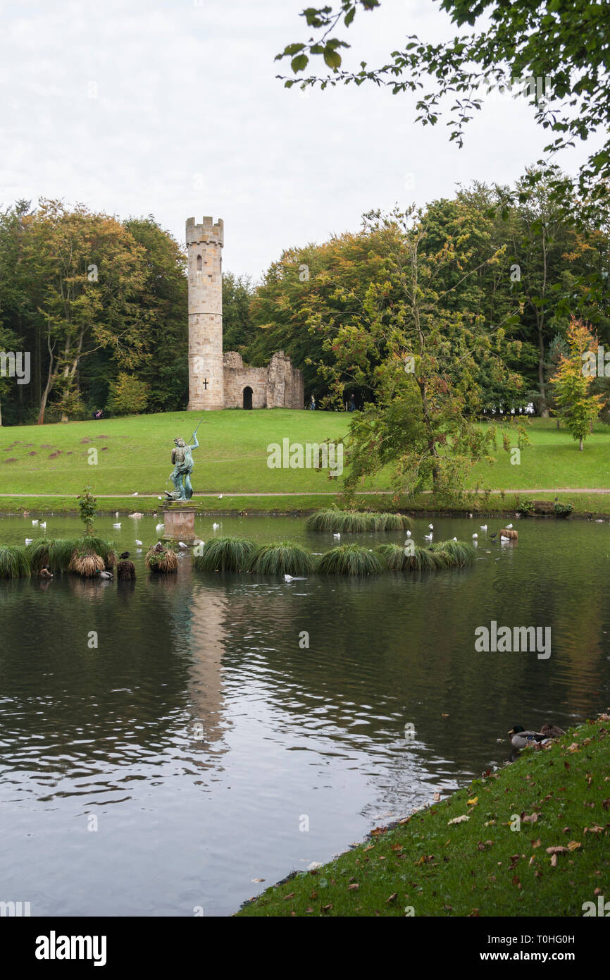 The Gothic Ruin and statue of Neptune on the lake at Hardwick Hall Park, Sedgefield, Co. Durham, England, UK Stock Photo