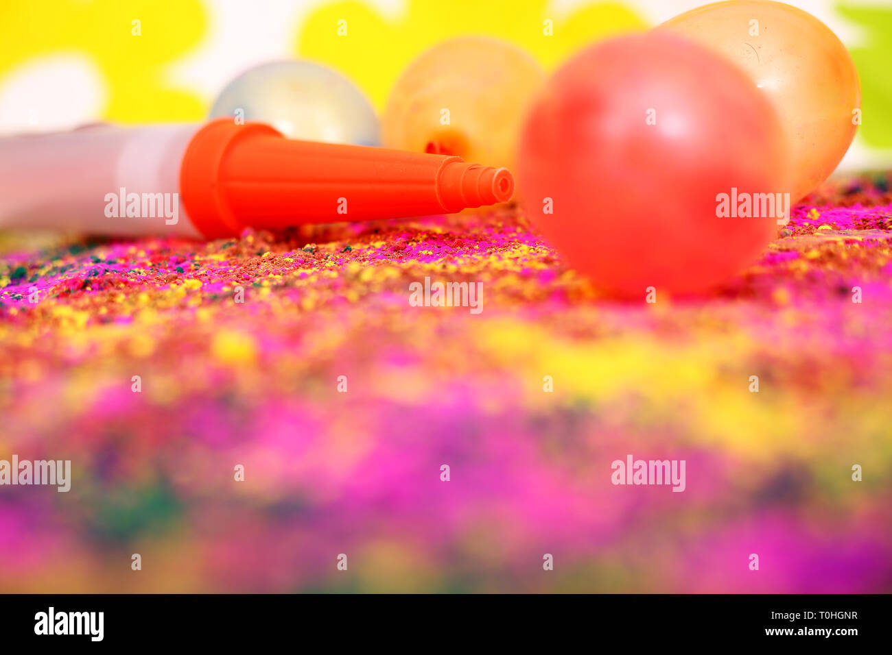 Picture of colorful balloons and pichkari for holi fun. Isolated on the  colorful background Stock Photo - Alamy