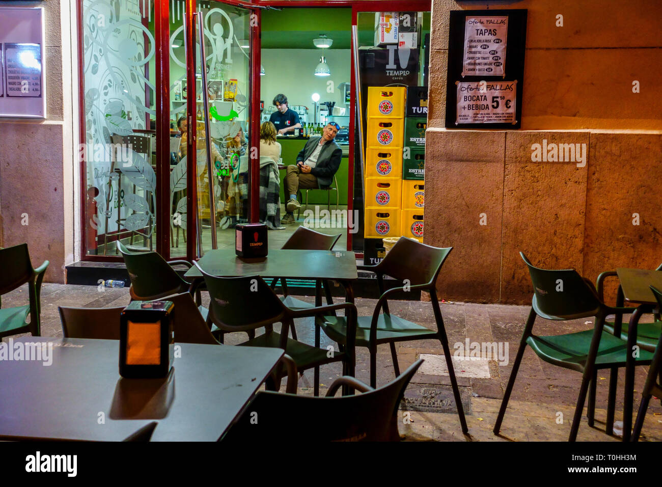 Valencia street bar, People inside bar in the Night, Spain Stock Photo