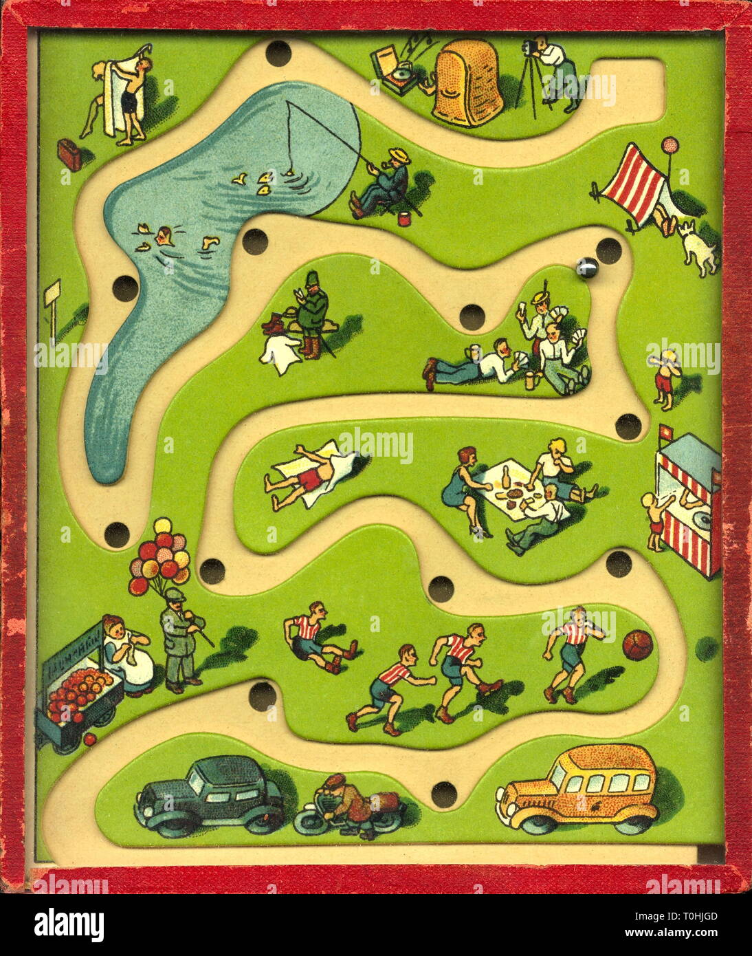 game, puzzle for children, funny weekend, small metal ball have to go through labyrinth, Germany, circa 1935, Additional-Rights-Clearance-Info-Not-Available Stock Photo