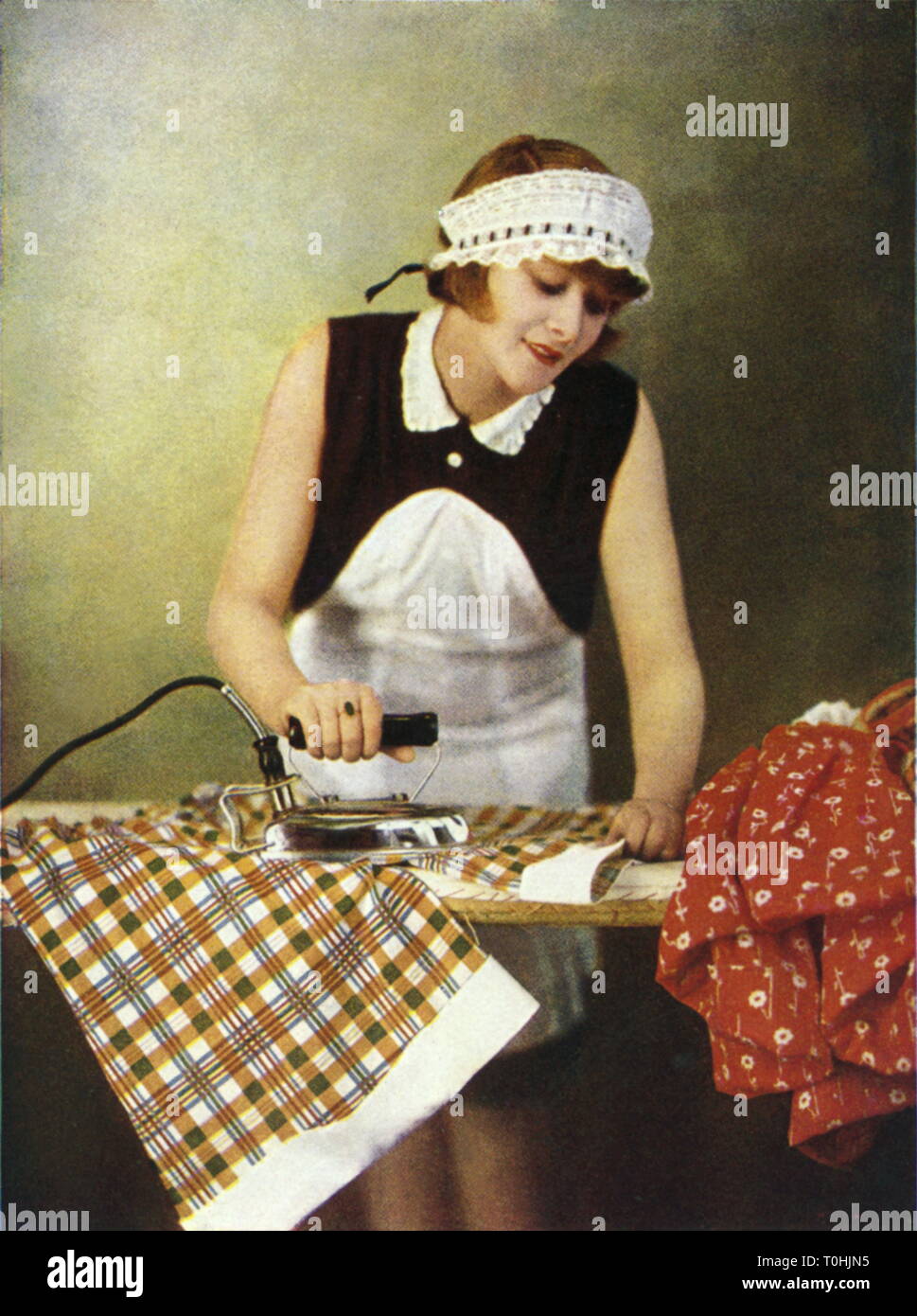household, ironing, AEG iron, caption: Ilse Baumann with the AEG electric iron, advertising postcard, Germany, circa 1929, Additional-Rights-Clearance-Info-Not-Available Stock Photo