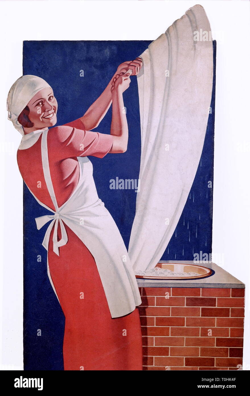 household, laundry, housewife with headscarf and white apron, fetching piece of laundry out of the leach, stand-up display, Germany, circa 1938, Additional-Rights-Clearance-Info-Not-Available Stock Photo