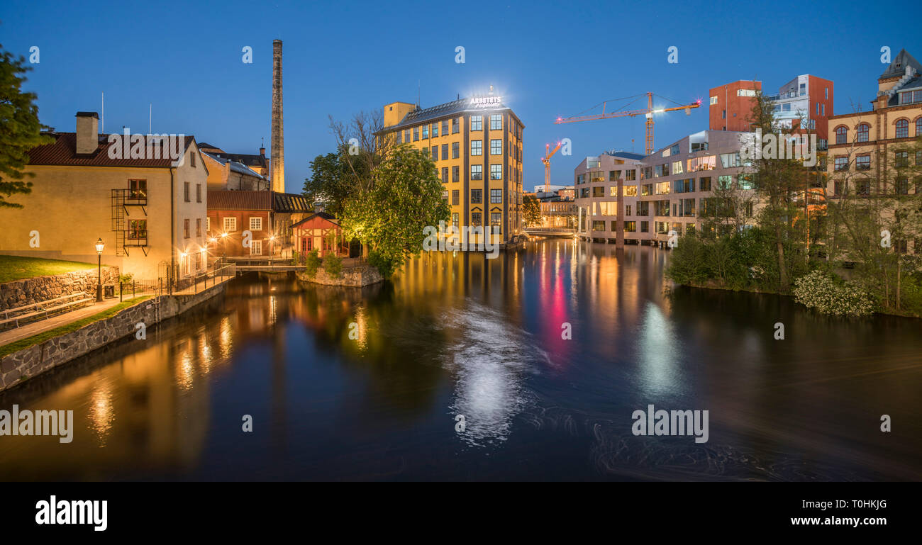 Old industrial buildings at the Motala strom river at night, Norrkoping, Sweden, Scandinavia Stock Photo