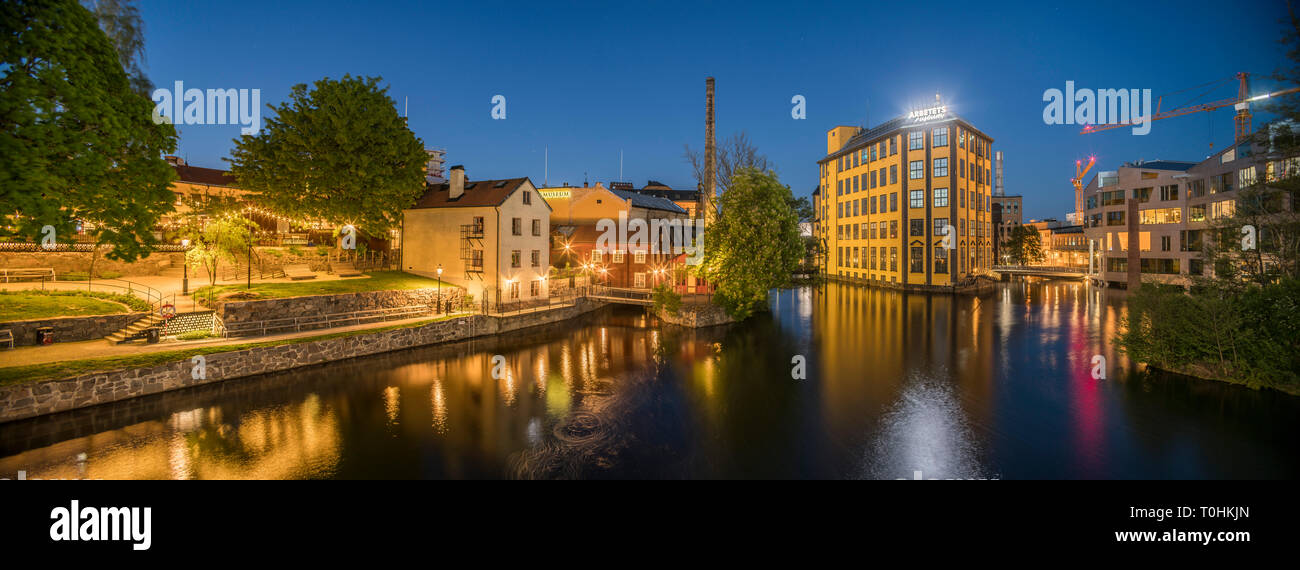 Old industrial buildings at the Motala strom river at night, Norrkoping, Sweden, Scandinavia Stock Photo