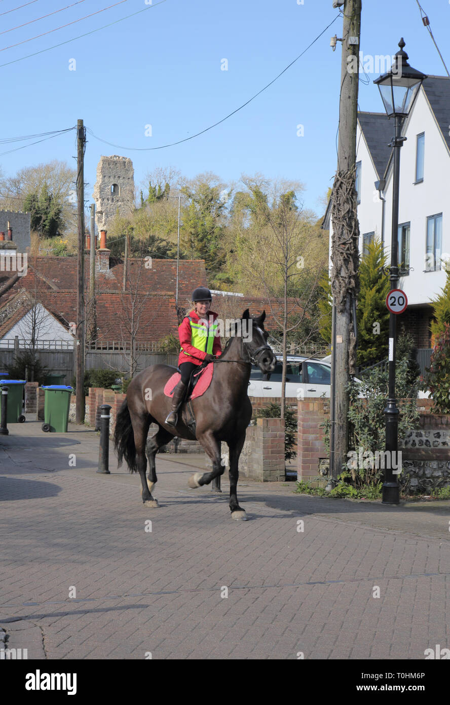 lady riding her horse in the small sussex village of bramber west sussex Stock Photo