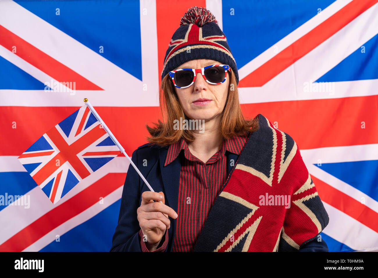 British redhead woman with UK flag onunited kingdom background Stock Photo