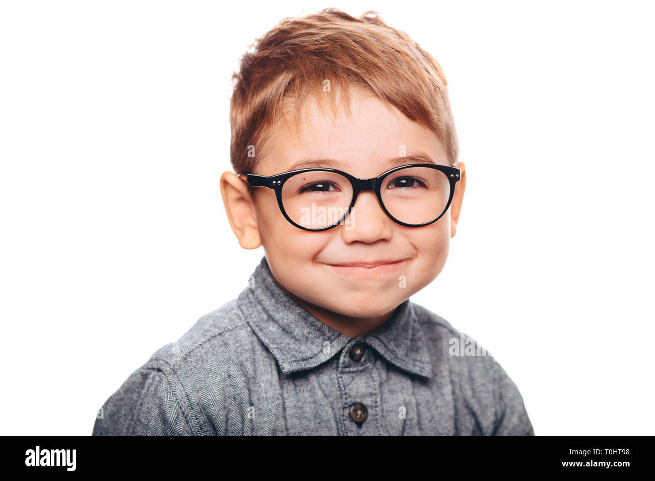 little boy with eyeglasses looking at camera on white background Stock Photo