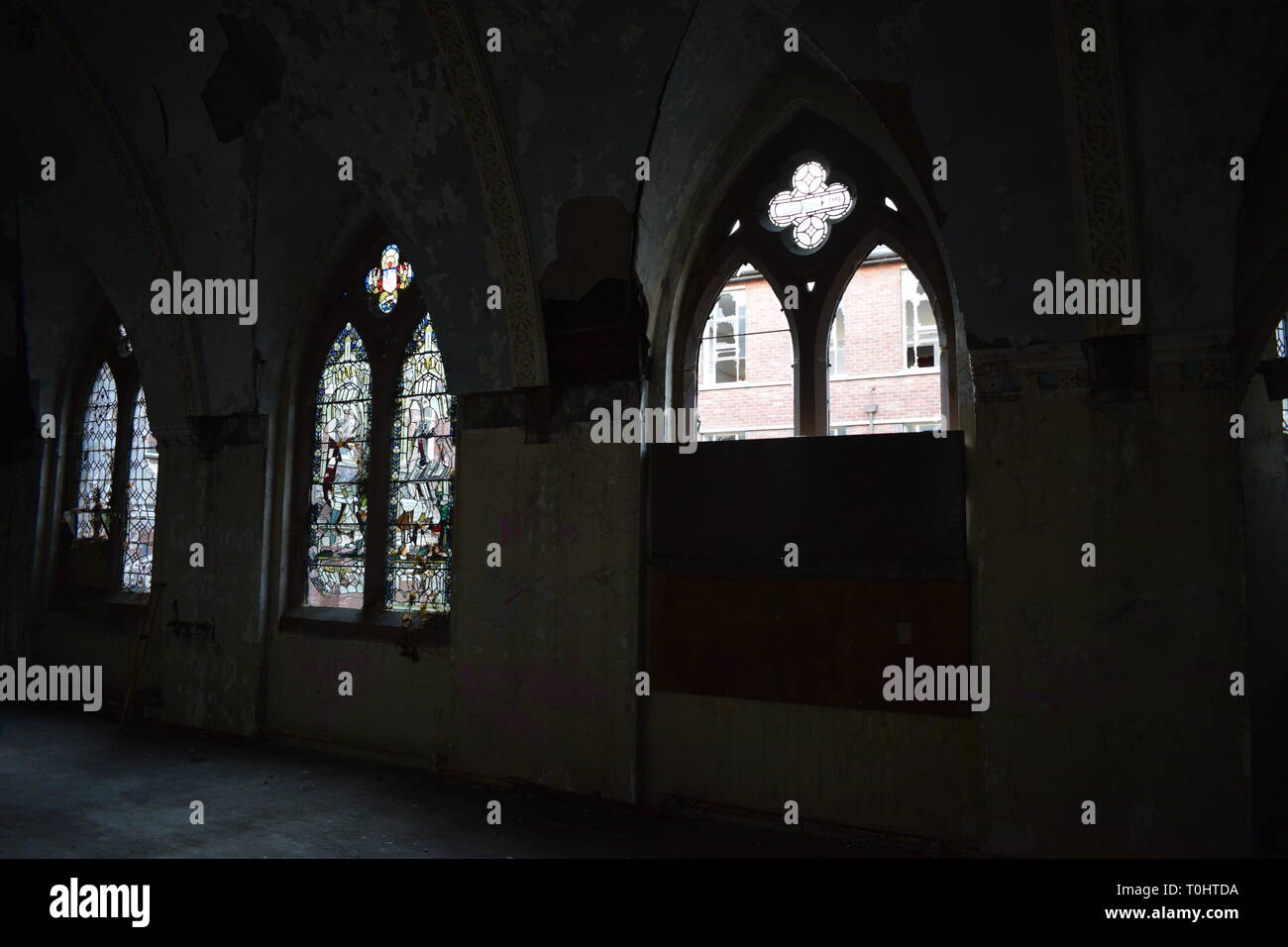 Shattered stain glass windows in abandoned church Stock Photo