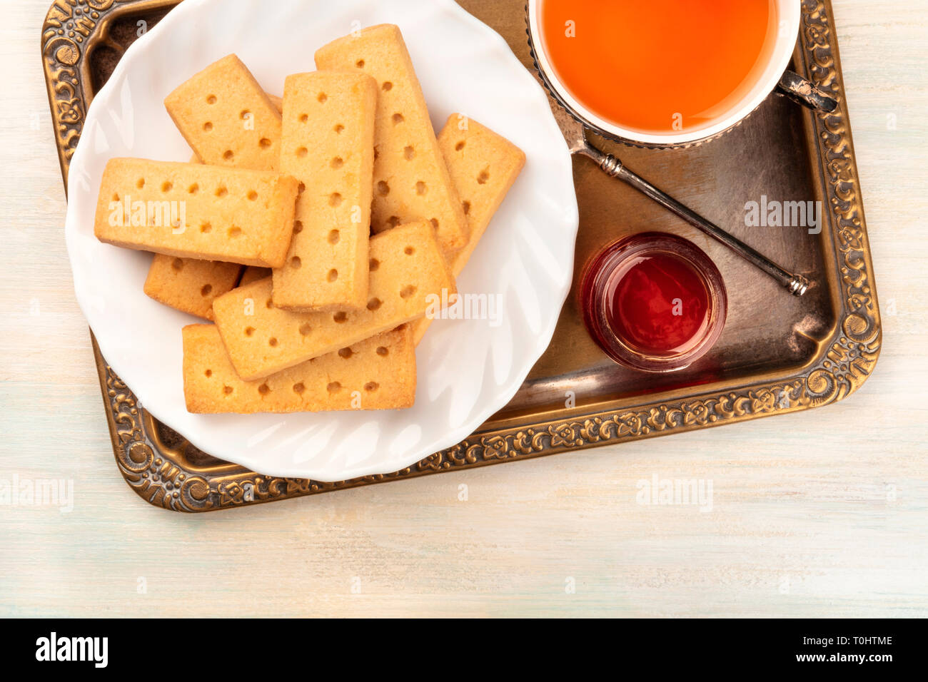 A closeup of Scottish shortbread butter cookies, shot from the top on a vintage tray with a cup