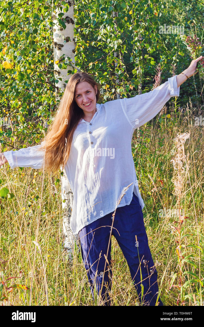 The Smiling Girl In A White Shirt With The Placed Hands In The