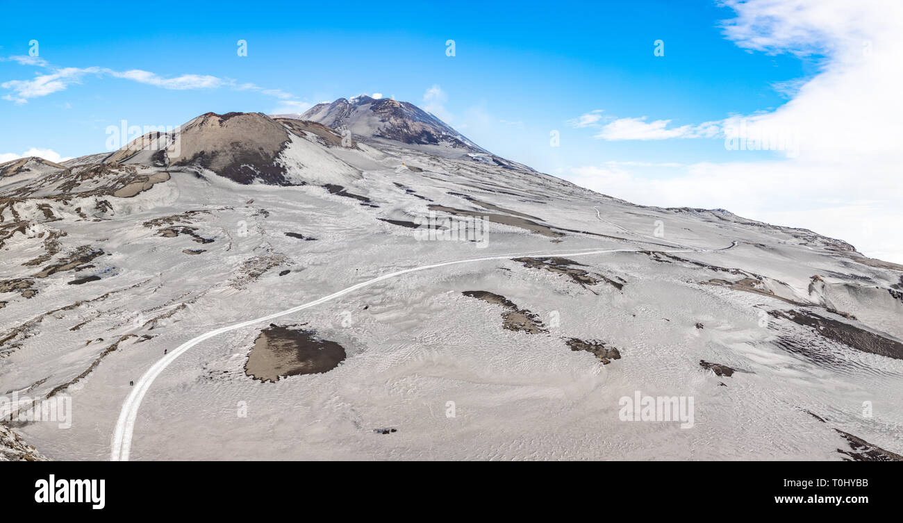 Footpath to Etna Volcano with smoke in winter, volcano landscape, Sicily island, Italy Stock Photo