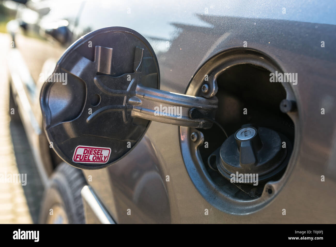Open fuel filler flap with the word DIESEL FUEL ONLY, the petrol cap is closed. Stock Photo