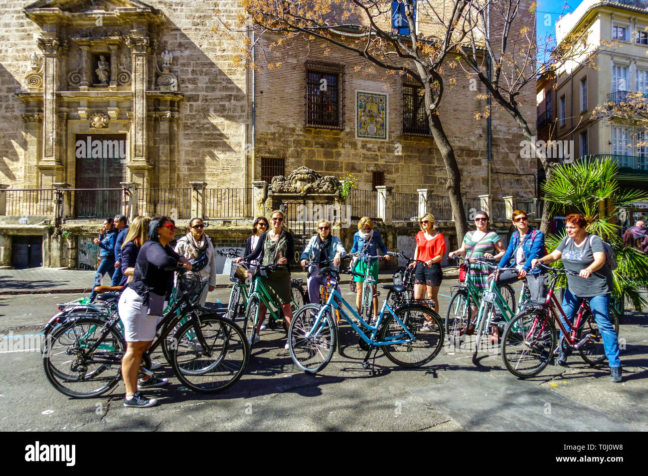 Valencia tourists Group of women on rental bike Valencia Old Town Spain bicycle city Bicycles in Valencia group cyclists city Stock Photo