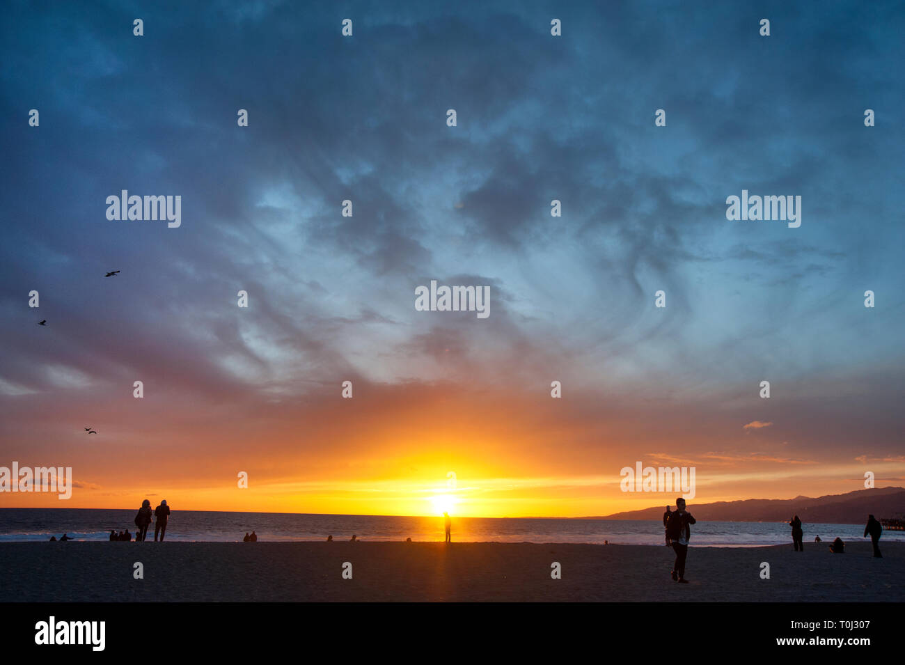 People on the beachat sunset in Santa Monica, CA Stock Photo