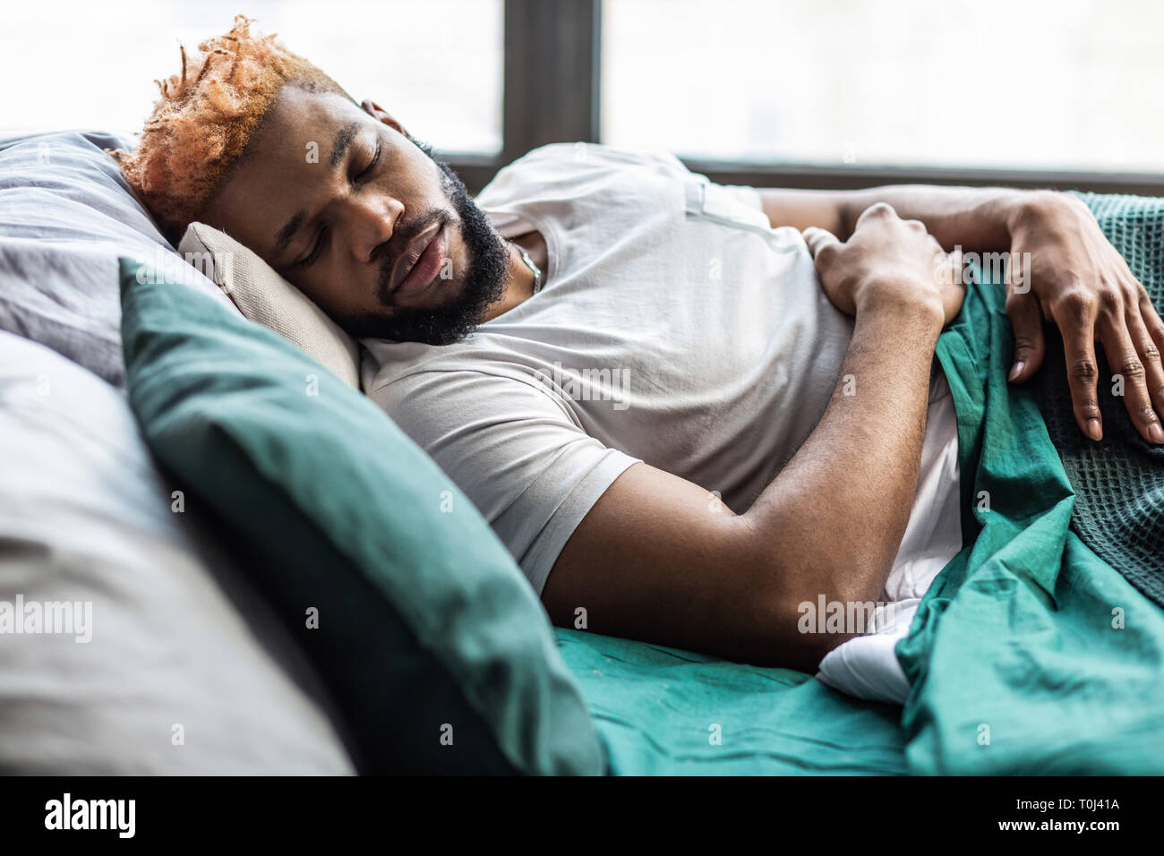 Handsome nice young man resting at home Stock Photo - Alamy