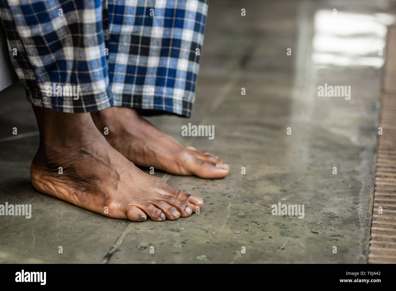 Feet of a nice African American man touching the floor Stock Photo