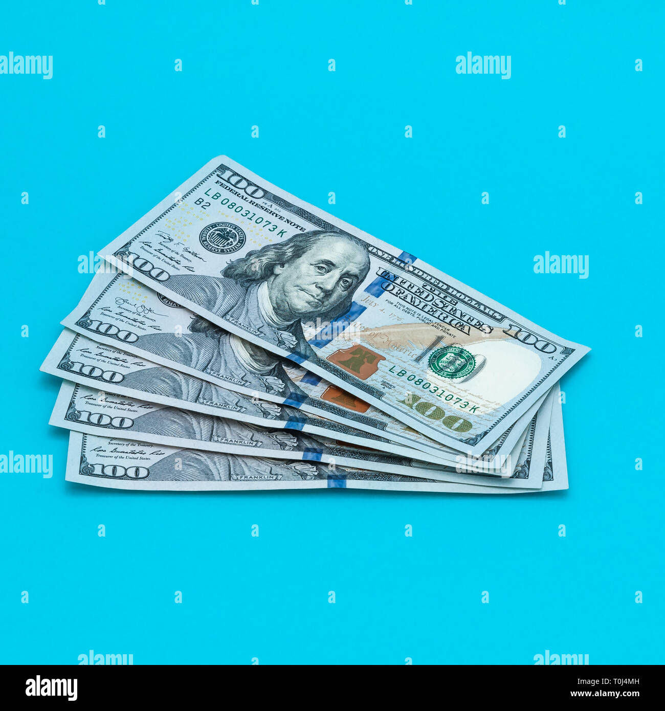 Dollars cash bills on a blue background Stock Photo Alamy