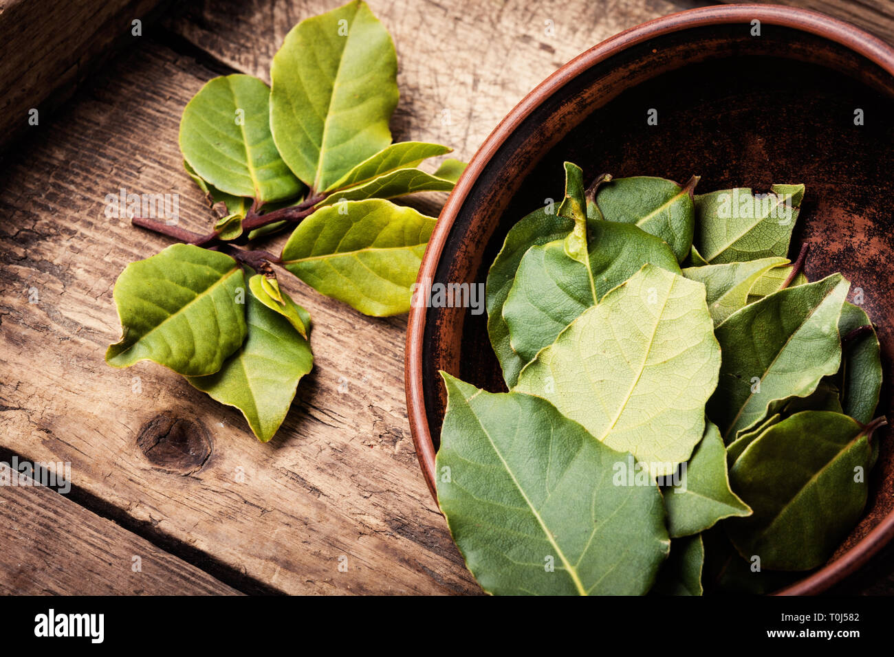 Bay Leaves In Bowl On Rustic Wooden Background Bay Leaf Is A