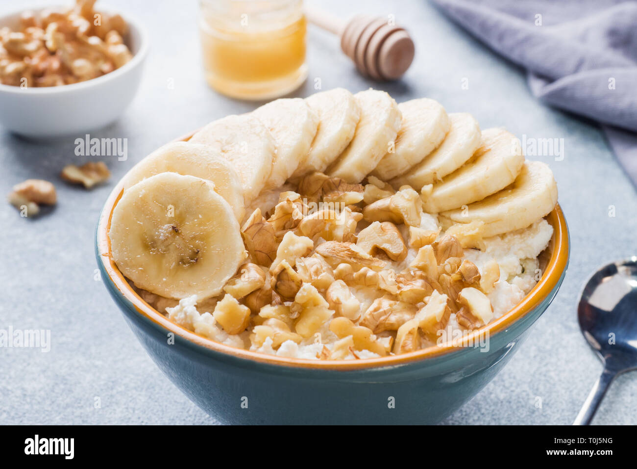 Healthy Breakfast Cottage Cheese With Banana And Walnuts On Grey