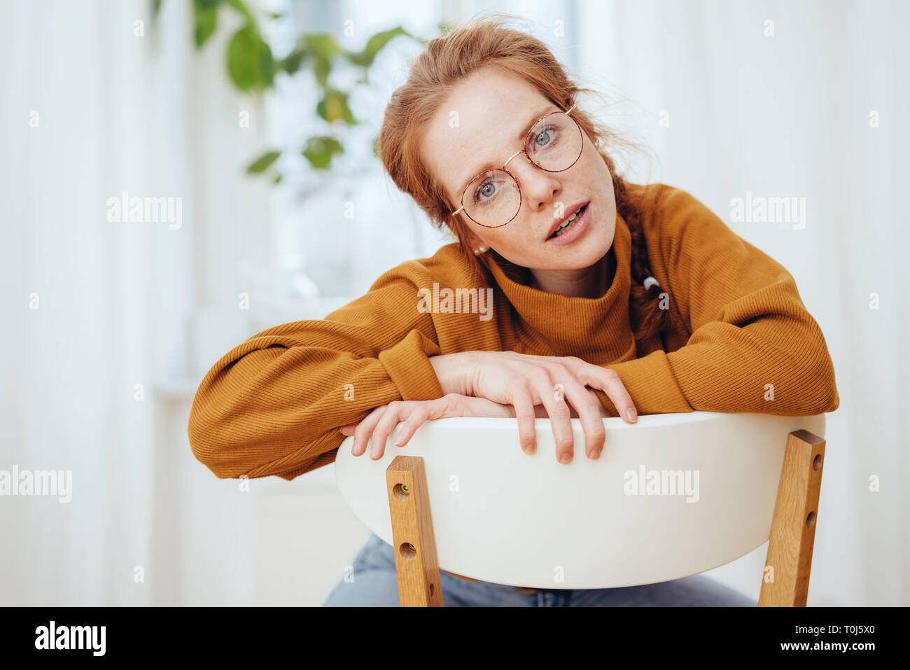 Woman leaning back in chair hi-res stock photography and images - Alamy