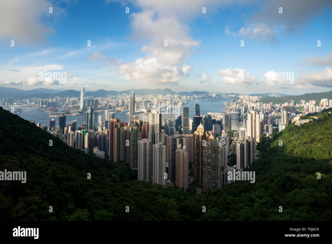 Aerial view of Hong Kong skyline and Victoria Harbor with blue sky in ...