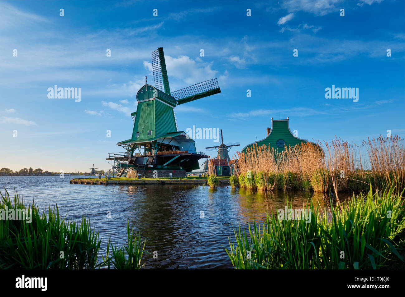 Windmills at Zaanse Schans in Holland on sunset. Zaandam, Netherlands Stock Photo
