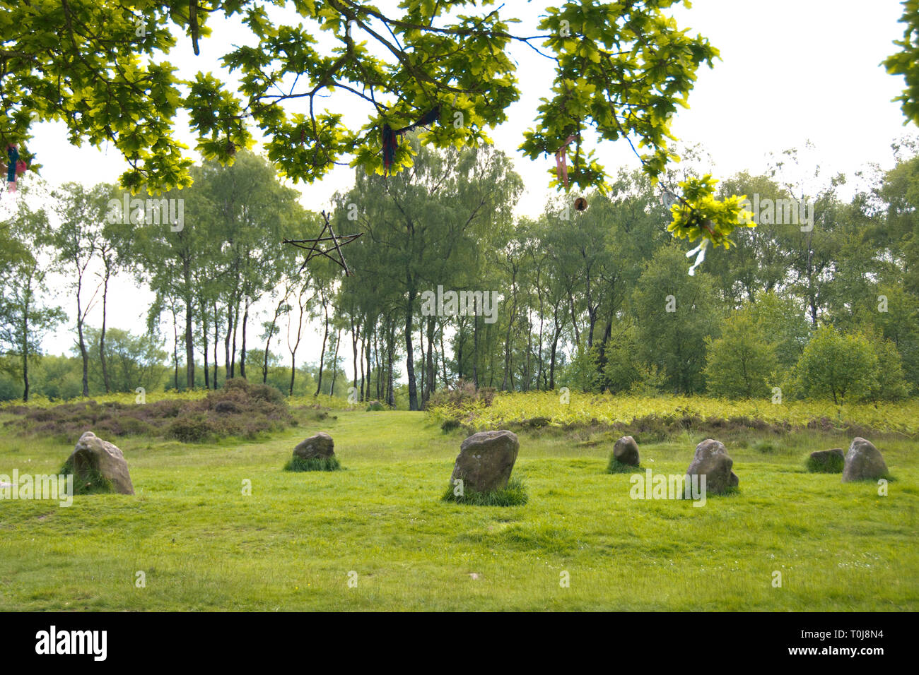 Derbyshire, UK – June 03 2016: offerings tied to the sacred oak  wishing tree beside Nine Ladies Stone Circle, a Bronze age monument on Stanton Moor Stock Photo