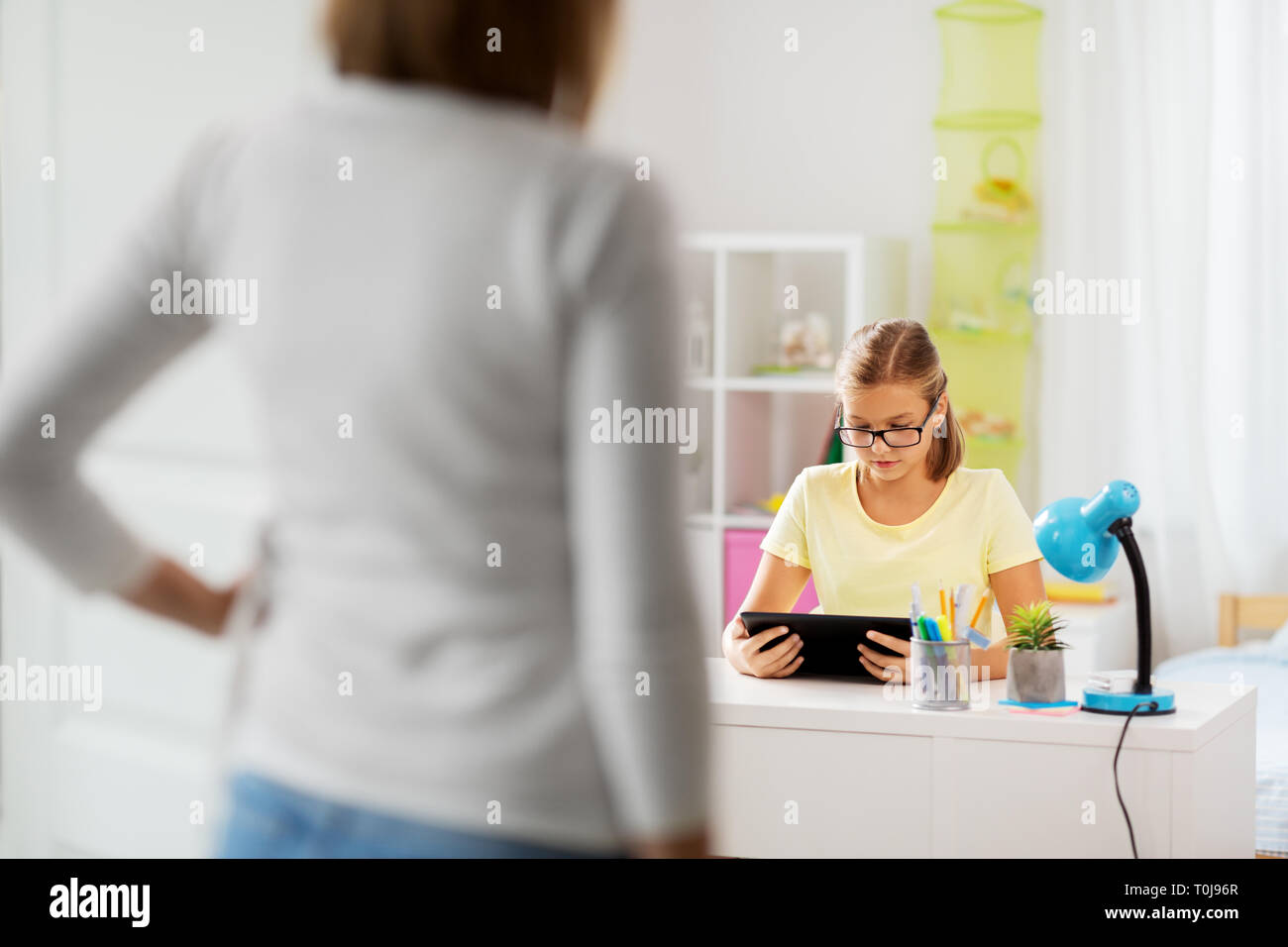 student girl using tablet computer during homework Stock Photo