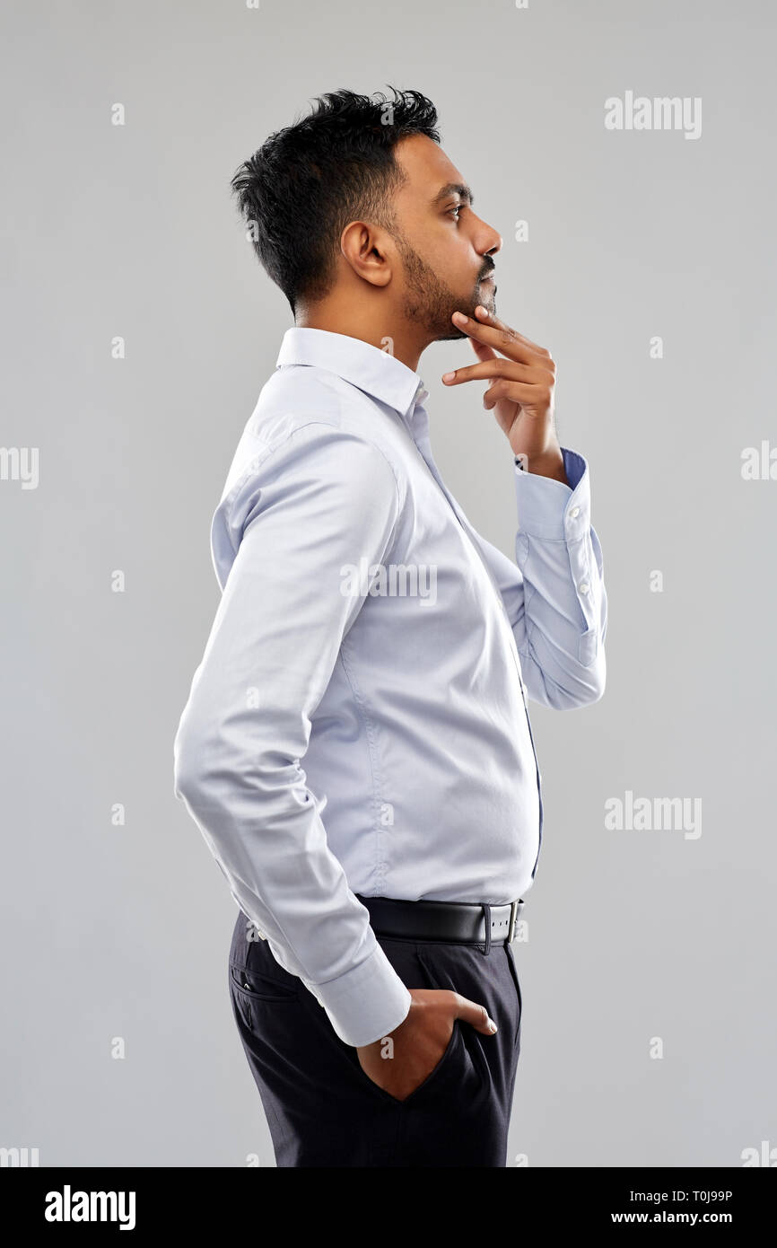 indian businessman side view over grey background Stock Photo