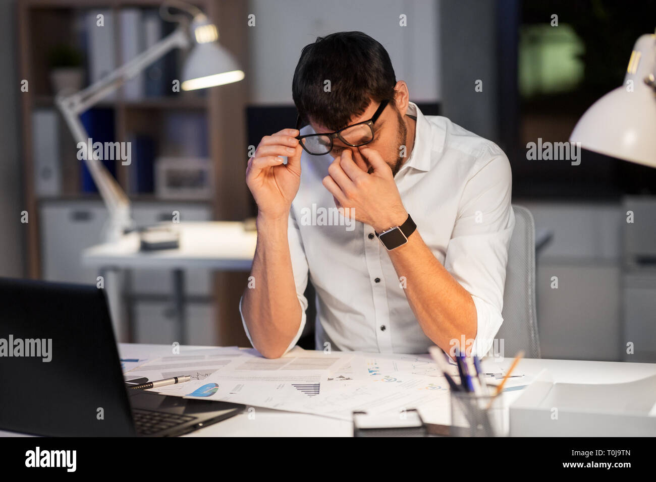 tired businessman working at night office Stock Photo