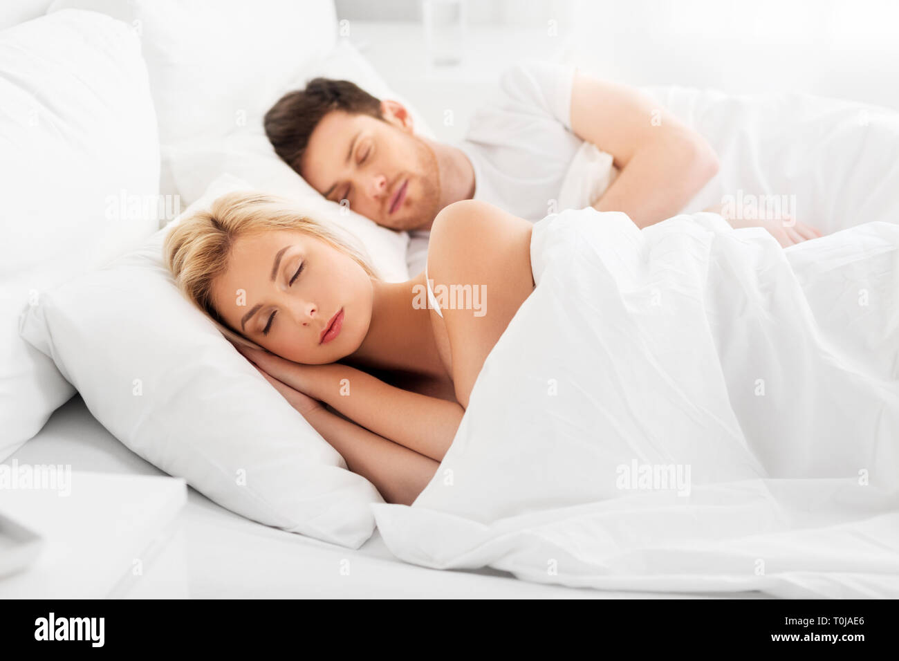 happy couple sleeping in bed at home Stock Photo - Alamy