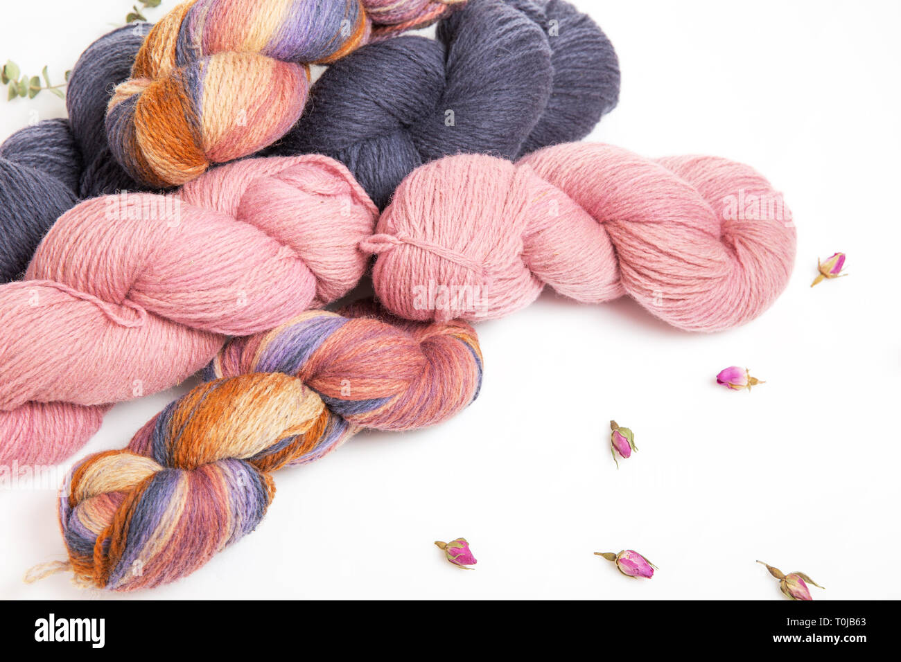 Pink, gray, multicolored yarn of wool in bundles for hand knitting