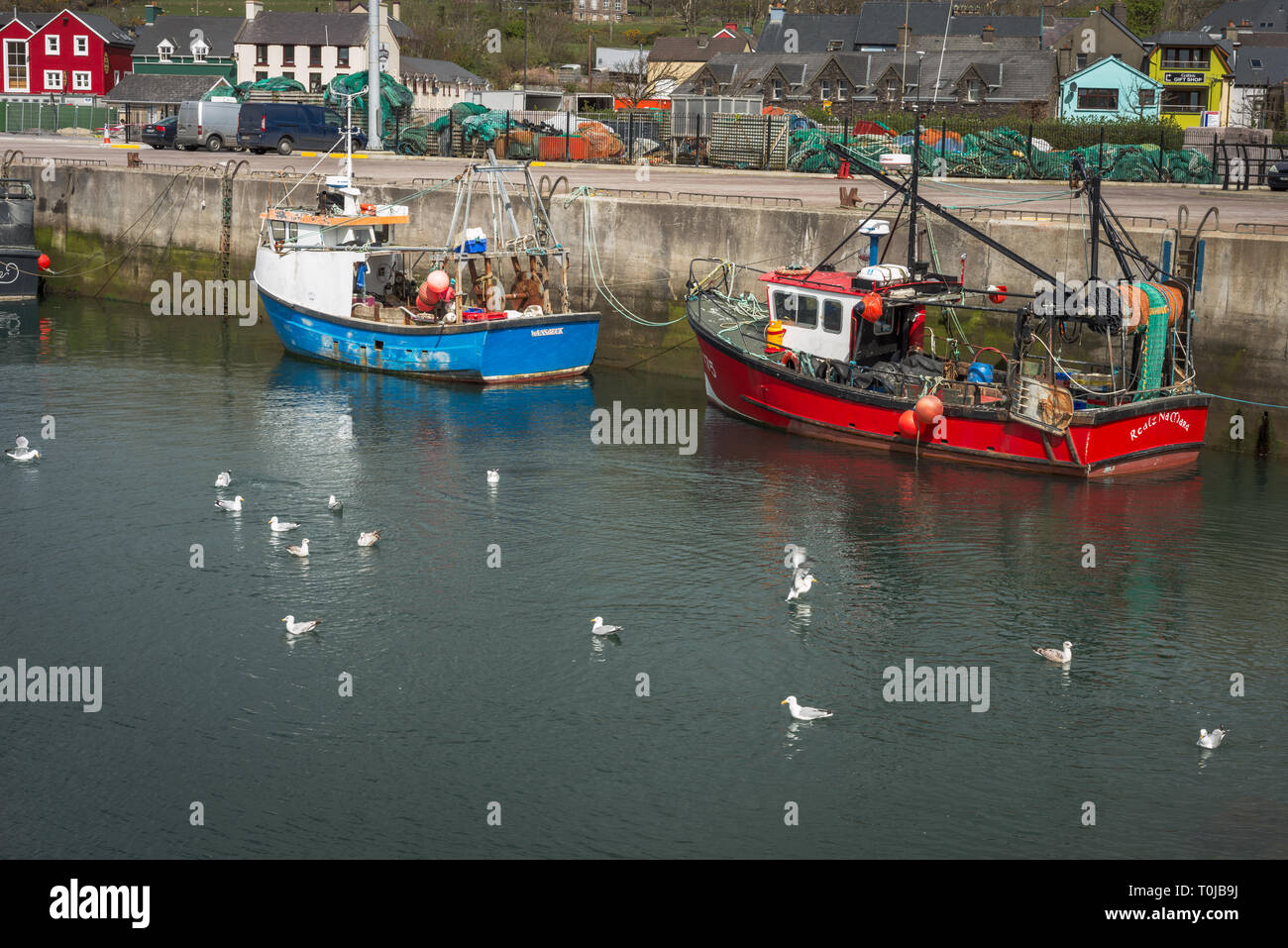Moored fishing motorboats in Dingle harbour, Dingle, County Kerry, Ireland Stock Photo
