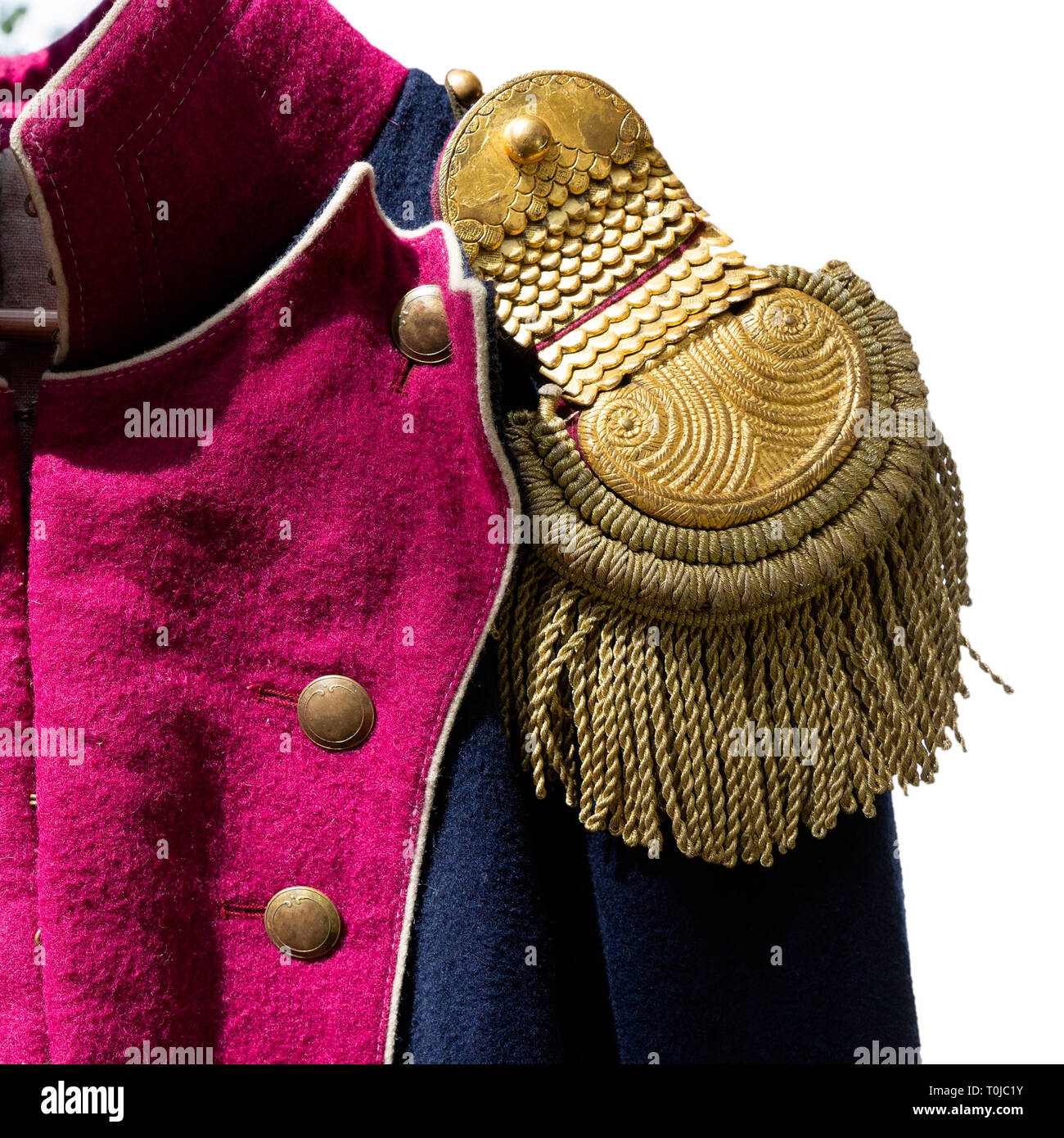 Details of a historic uniform of a French army of the Napoleon wars era. Closeup view of an epaulette. Isolated against the white background Stock Photo