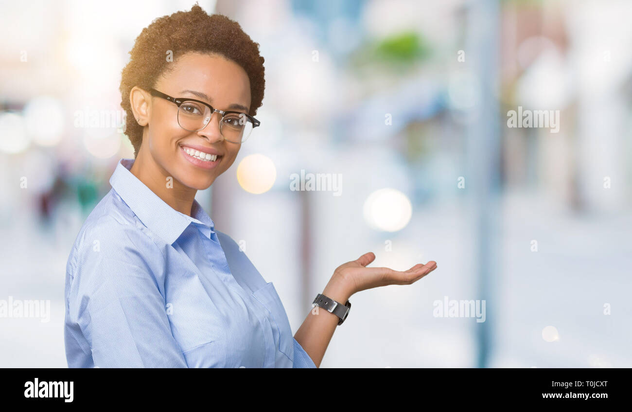 Young beautiful african american business woman over isolated ...