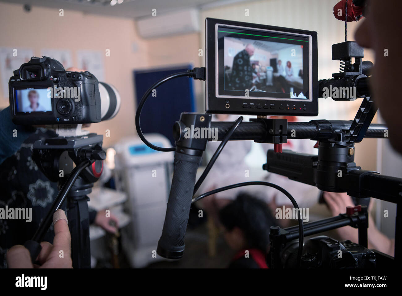 Video cameras on the set, backstage of the movie scene, operator hands Stock Photo
