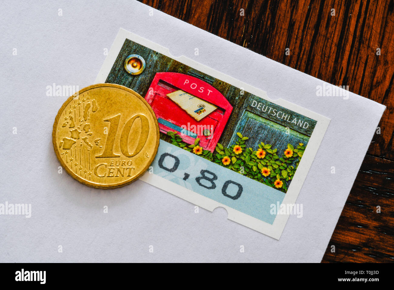 German stamp 80 cents and 10 cent coins, symbolic photo Portoerhöhung, Deutsche Briefmarke 80 Cent und 10 Centmünze, Symbolfoto Portoerhöhung Stock Photo