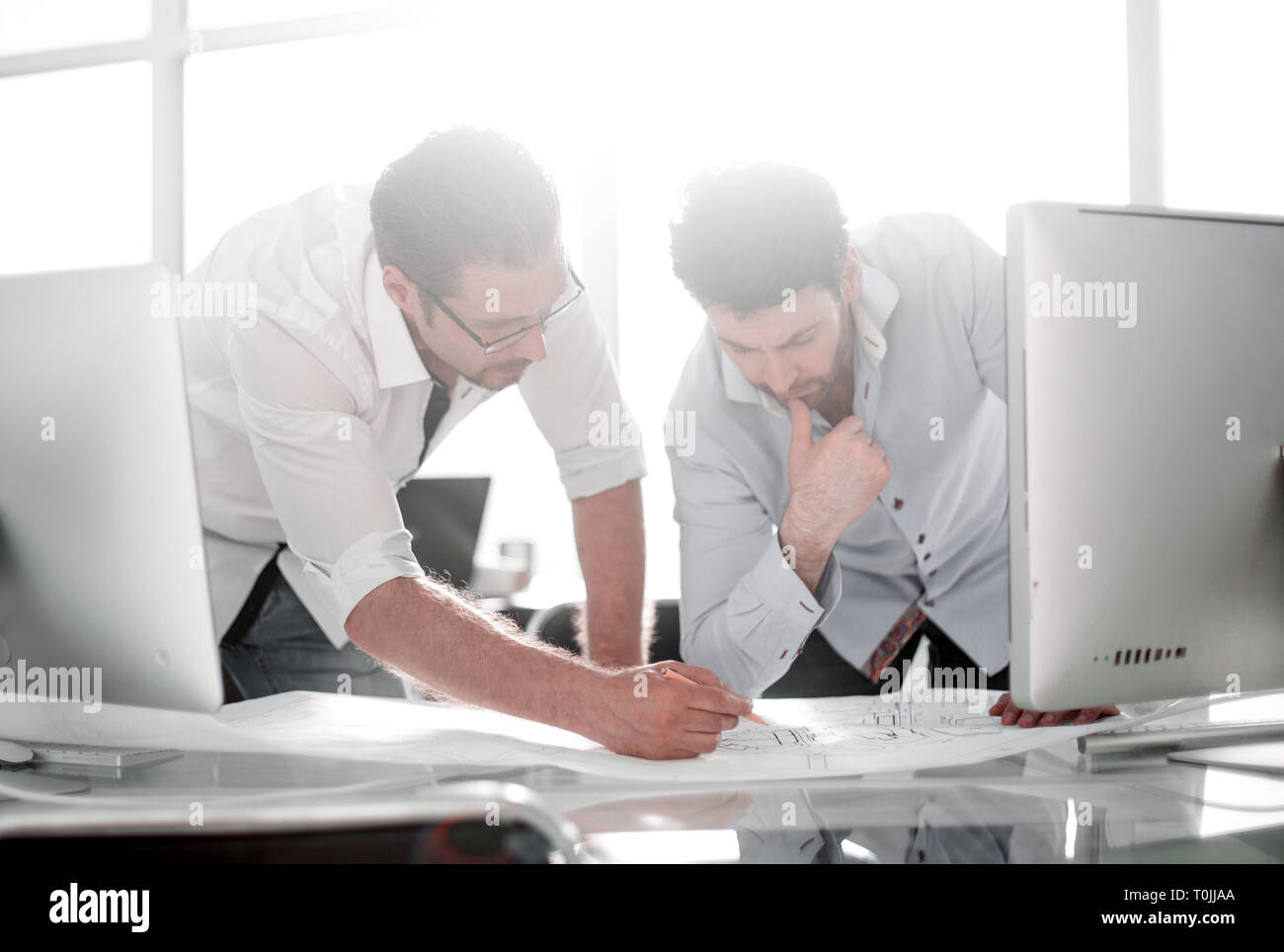 background image. architect discuss drawings in the office Stock Photo