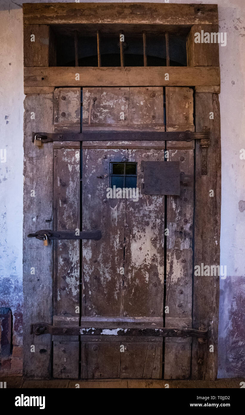 Very old wooden door with rusty steel door fittings on prison of castle Ljubljana in Slovenia, Europe Stock Photo