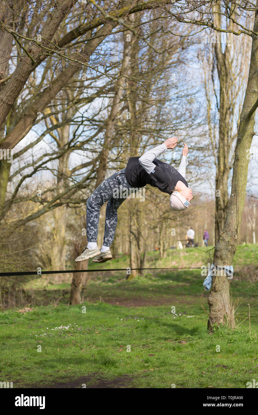 Kidderminster, UK. 20th Mar, 2019. UK weather: with beautiful sunny weather today young people celebrate the spring equinox by jumping into action. Young guys in a local park set up a tightrope and practise a few spring jumps of their own! Credit: Lee Hudson/Alamy Live News Stock Photo